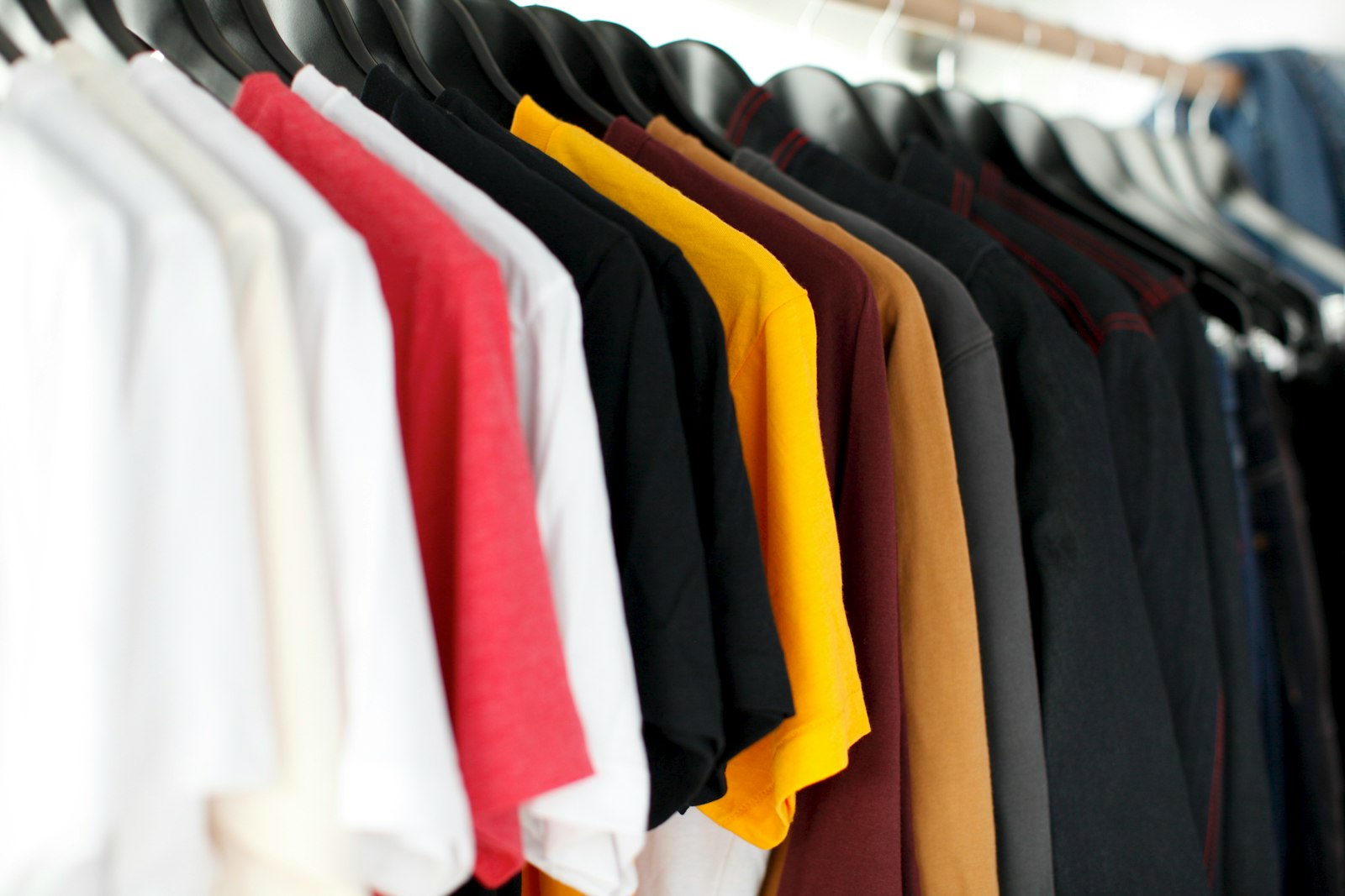 Deretan kaos katun tergantung di rak toko